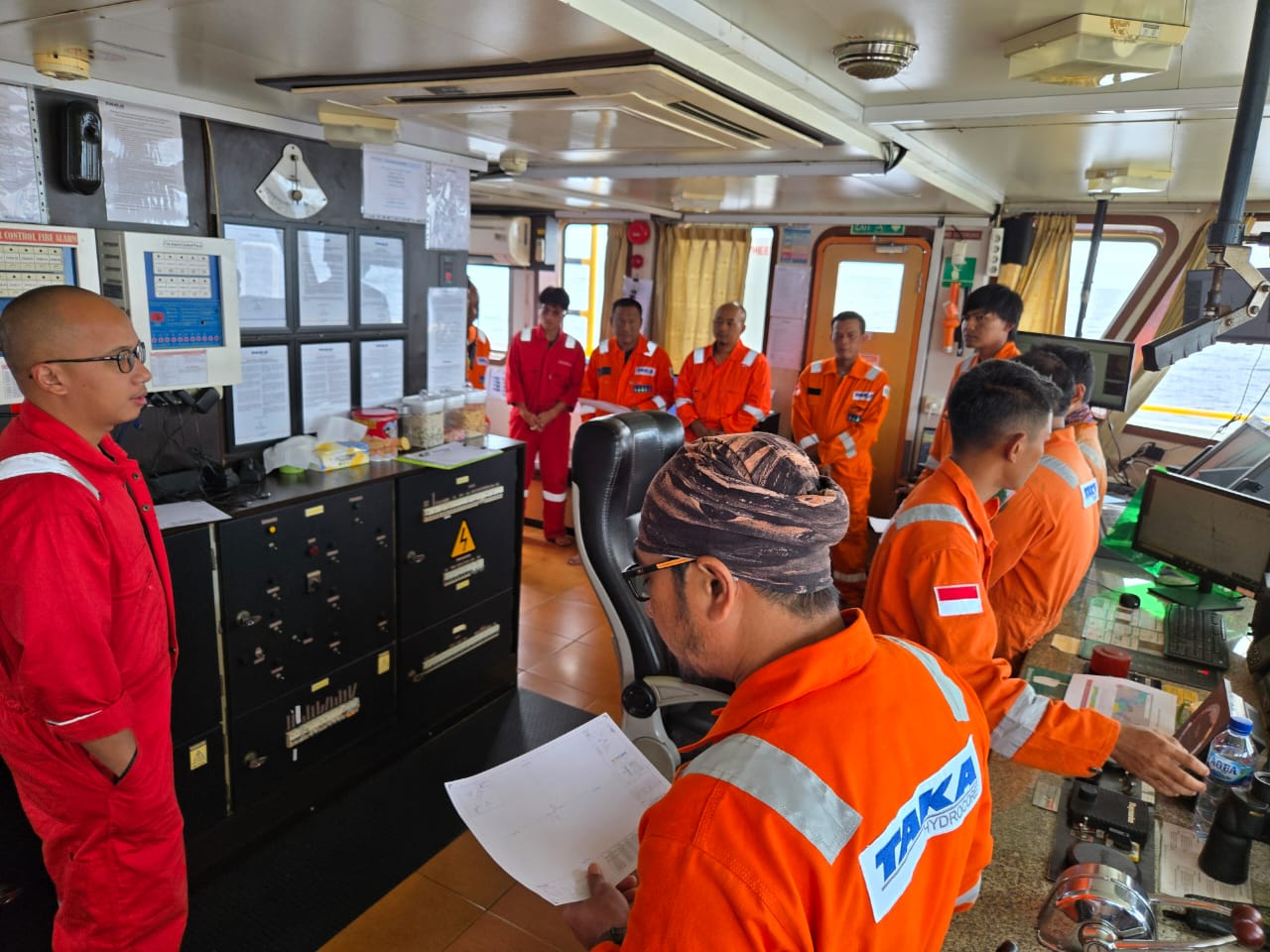 Crew operating a vessel bridge